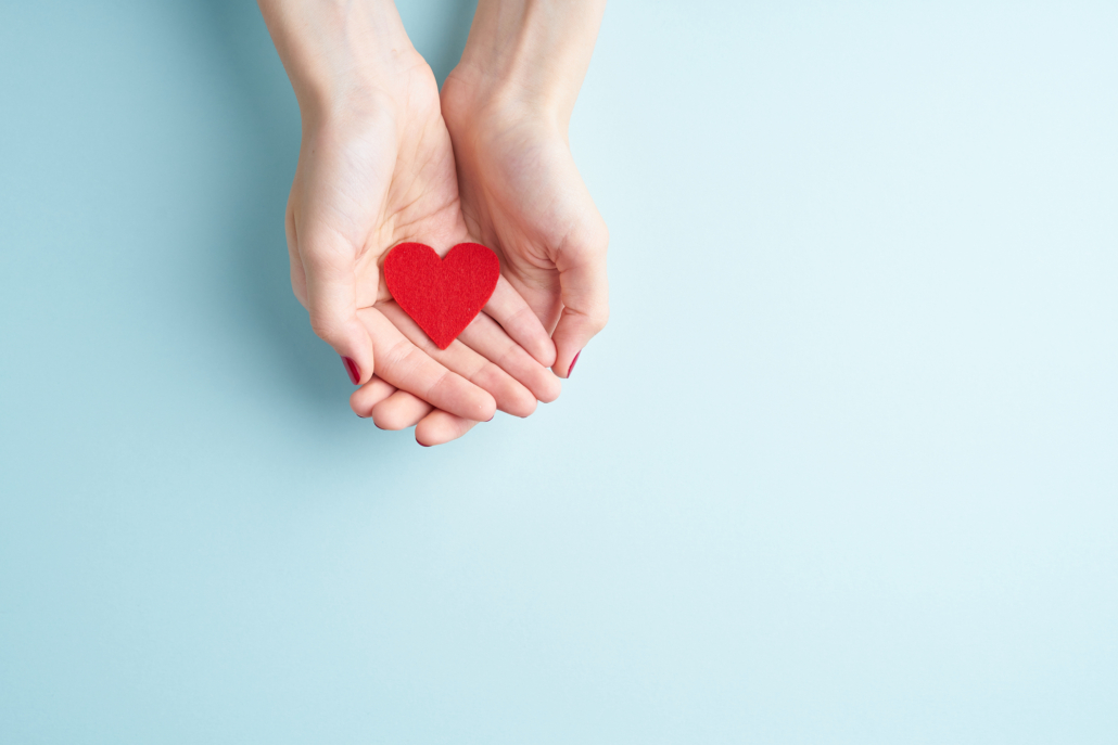 A person holding a heart symbolizing front-loading a Donor Advised Fund