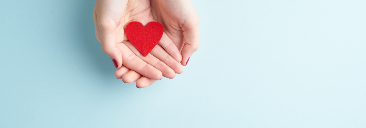 A person holding a heart symbolizing front-loading a Donor Advised Fund