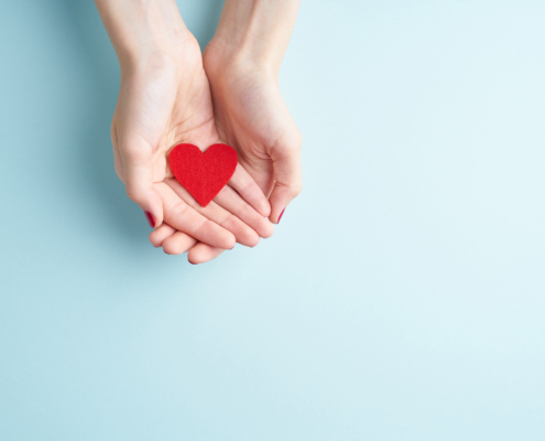 A person holding a heart symbolizing front-loading a Donor Advised Fund