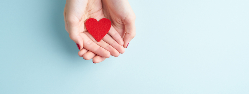 A person holding a heart symbolizing front-loading a Donor Advised Fund
