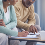 A couple discussing donating and unneeded insurance policy