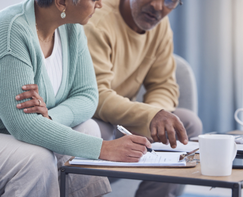 A couple discussing donating and unneeded insurance policy